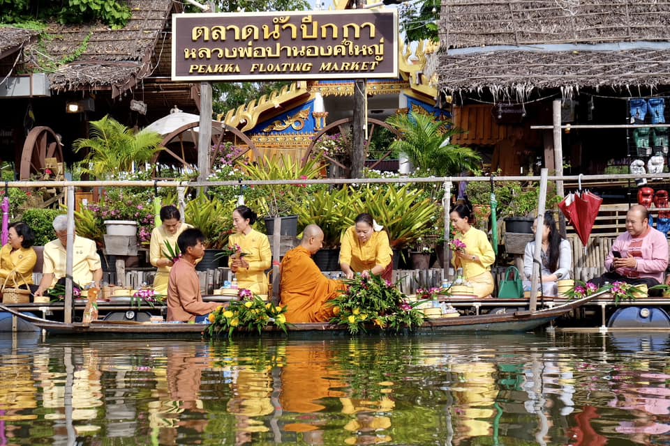 A vibrant floating market at a Buddhist temple at sunrise